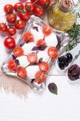 Naklejka na ściany i meble mozzarella, cherry tomatoes and fresh basil - ingredients for caprese salad