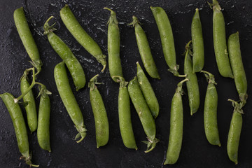 pods of green peas on a wooden table, rustic style,healthy food