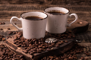 coffee cup with roasted  beans on wooden background
