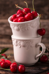  Ripe Cherries on wooden table with water drops