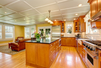 Design of brown wooden kitchen  with steel appliances