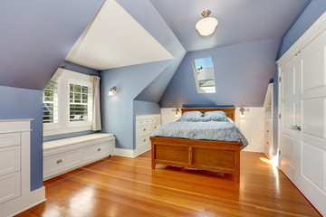 Lavender interior of attic bedroom with queen size bed