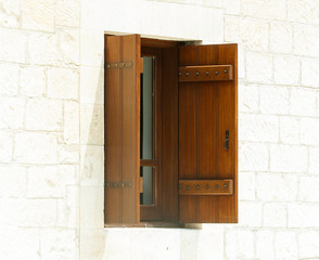 open wooden window against a white  wall