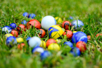 Colorful marbles in green grass