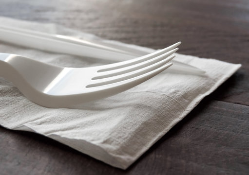 Plastic Dish Ware On A Wooden Table, Close Up Shot