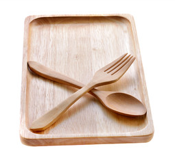 Wooden plate with Fork and spoon isolated on white background
