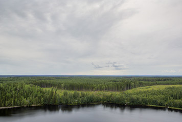 A view from high. An image of a Finnish landscape from the top of the hill. Dramatic clouds are in the sky.