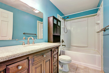 Interior design of blue bathroom in apartment