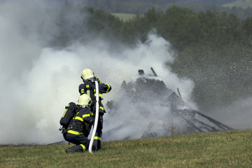 Firefighters extinguish fire fire vehicle