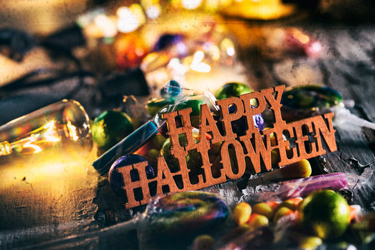 Halloween: Happy Halloween With Candy And Glowing Bulbs