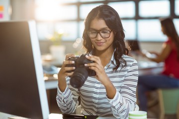 Business executive checking photos in camera