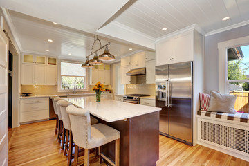 White interior of kitchen room with large kitchen island.