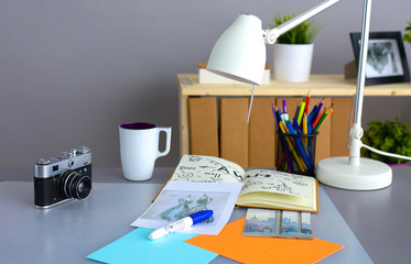 Desk of an artist with lots  stationery objects. Studio shot on wooden background