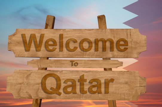 Welcome to Qatar sign on wood background with blending nationa