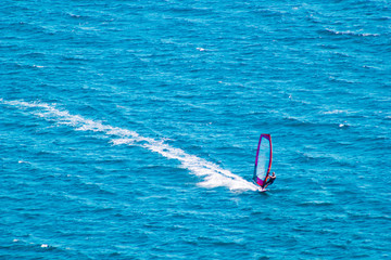Windsurfer on blue sea