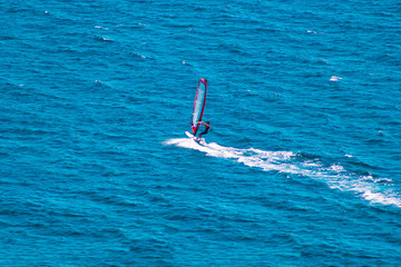 Windsurfer on blue sea