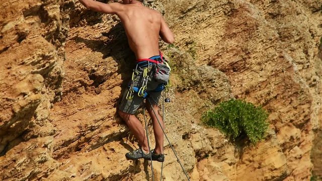 Extreme Climber Climbing On A Rock Without Insurance