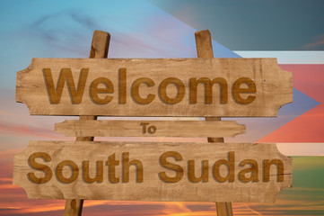 Welcome to South Sudan sign on wood background with blending nationa