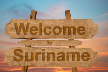 Welcome to Suriname sign on wood background