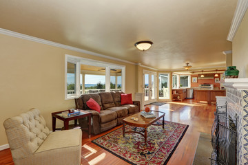 Craftsman-style family room with brown sofa and fireplace.