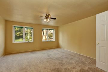 Empty room in beige and yellow colors with carpet floor