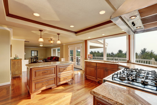 Photo of open concept kitchen with cabinets and granite countertops.