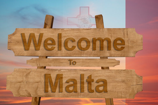 Welcome to Malta sign on wood background with blending nationa