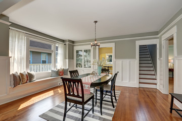 View of a classic dining room with gray walls and hardwood floors