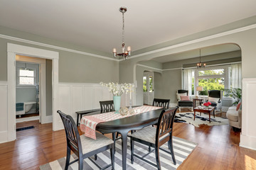 View of a classic dining room with gray walls and hardwood floors