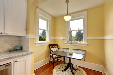 Small dining room area with yellow walls