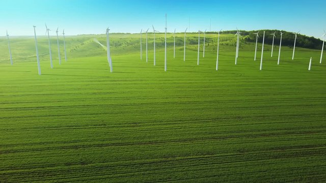 Aerial fly over grow up building wind turbines generating energy