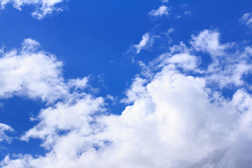 Blue sky background with white clouds. The vast blue sky and clouds sky on sunny day. White fluffy clouds in the blue sky.