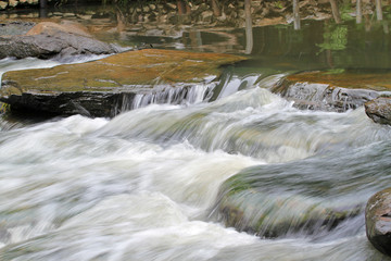 waterfall flow over stone in the river