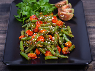 Healthy green beans, red cherry tomato with sesame seeds