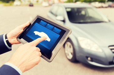 close up of male hands with car icon on tablet pc