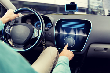 close up of man driving car with audio system