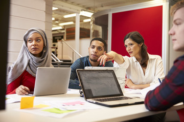 Group Of Students Meeting For Tutorial With Teacher