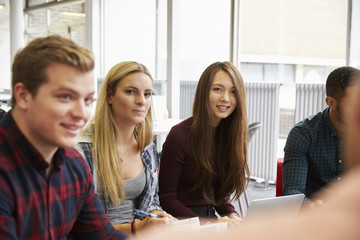 Group Of Students In Library Collaborating On Project