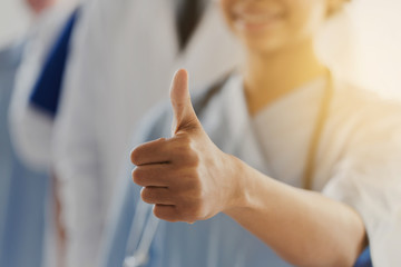 close up of doctor or nurse showing thumbs 