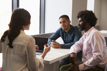 Father And Son Meeting With Female Teacher