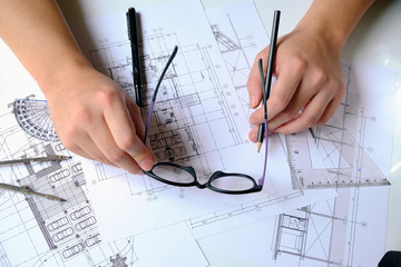 Close up man working of Architect sketching a construction project on his plane project at site construction work