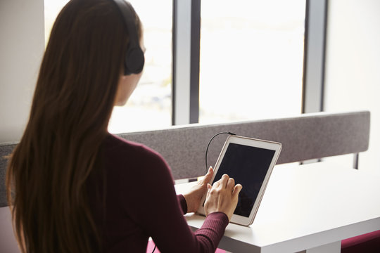 View Over The Shoulder Of Female Student With Digital Tablet