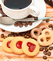 Mug of freshly brewed coffee and heart cookies
