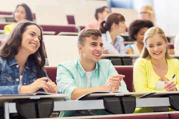 group of students with notebooks in lecture hall