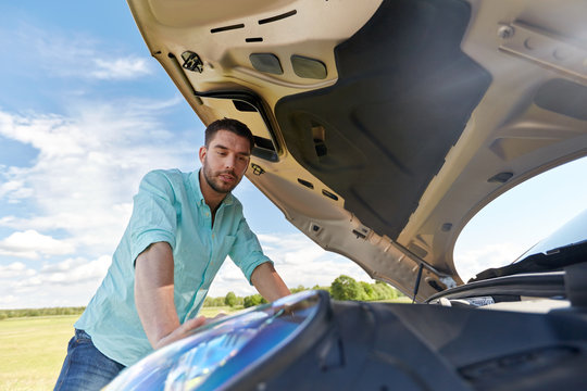 Man With Open Hood Of Broken Car At Countryside