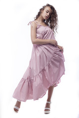 A beautiful young woman standing full length in a summer dress, isolated for white background. 