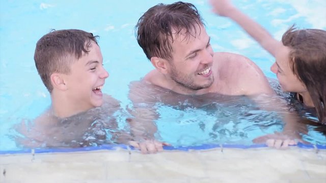 Happy family enjoying in pool