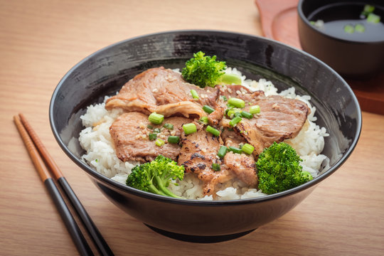 Roasted pork with stir fried broccoli and japanese rice in bowl, filtered image