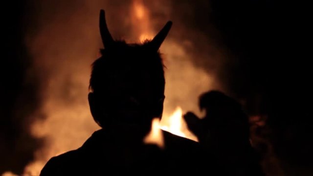 silhouette devil hell on the background of fire