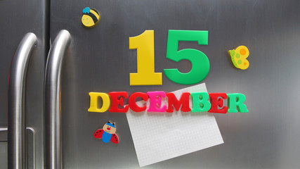 December 15 calendar date made with plastic magnetic letters holding a note of graph paper on door...